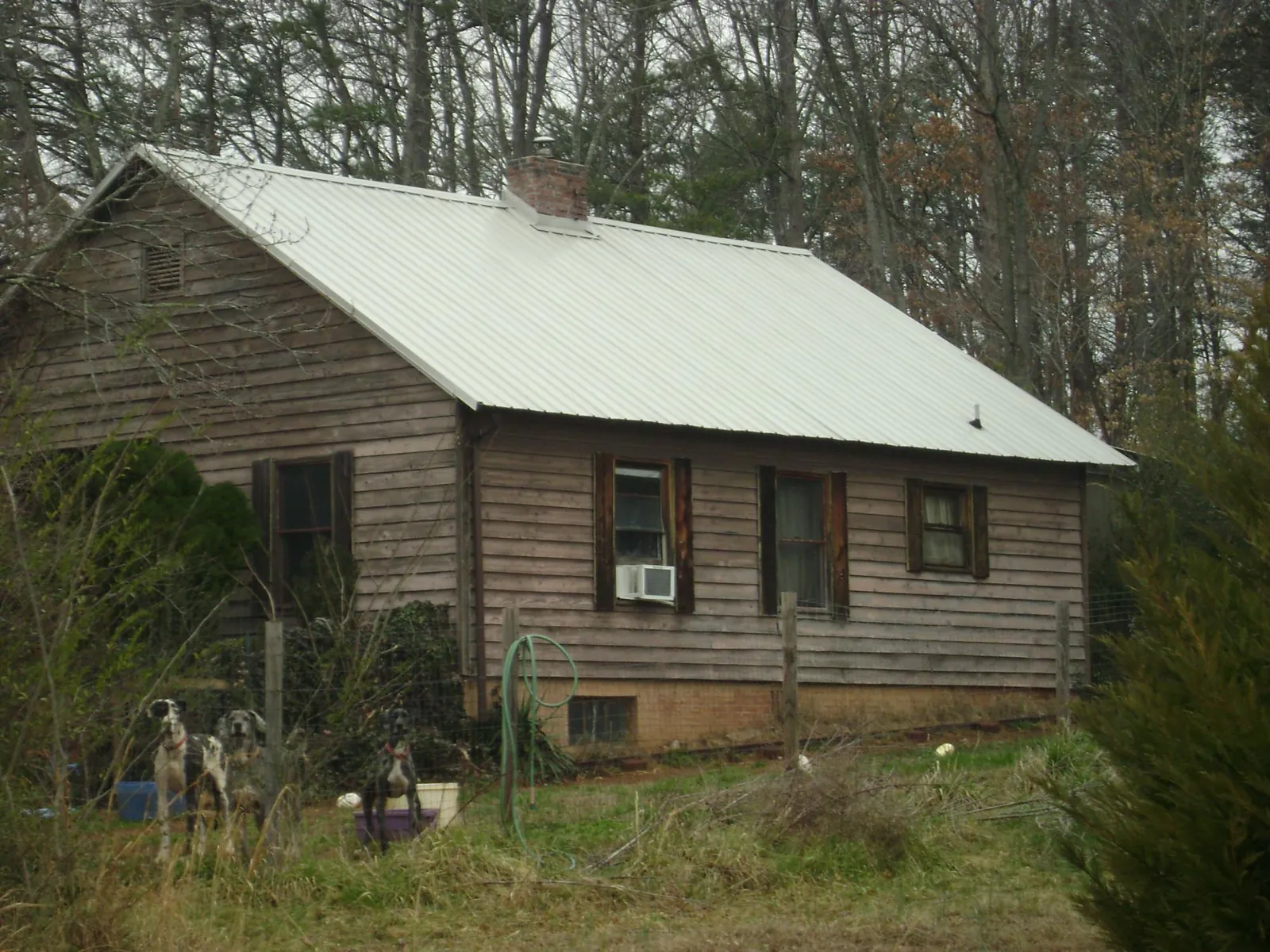 White metal roof on an old wood sided farmhouse, from a Metal Roof Installation job in Wisner